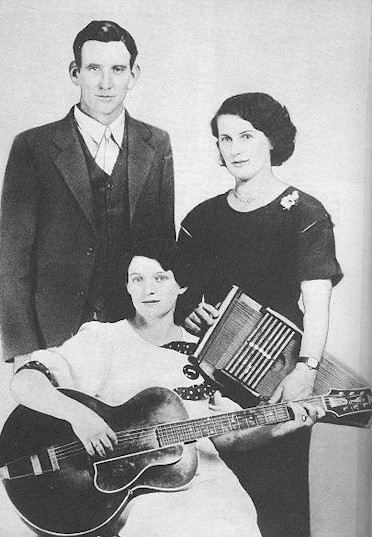 Promotional portrait of the Carter Family with guitar and autoharp