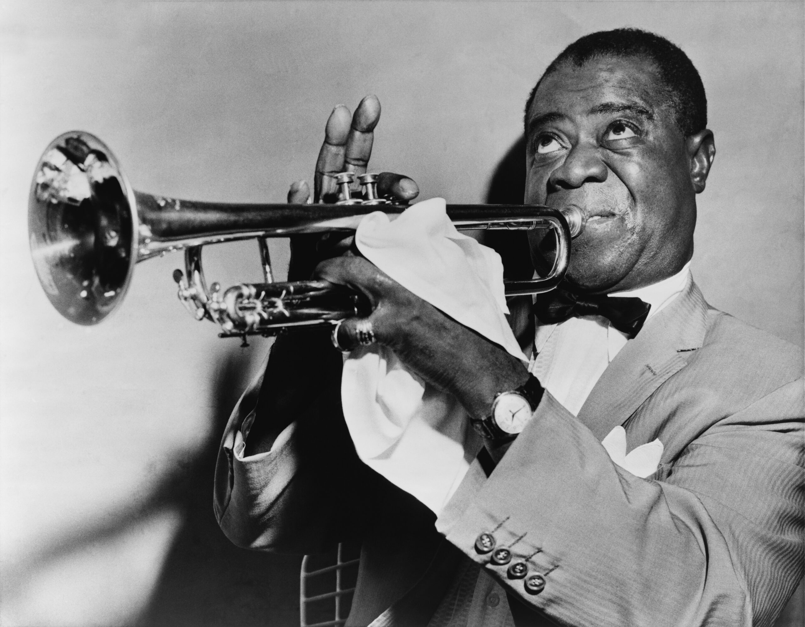 Louis Armstrong holding a trumpet in a 1953 portrait photograph