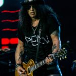 Slash playing guitar on stage with Guns N' Roses in June 2017