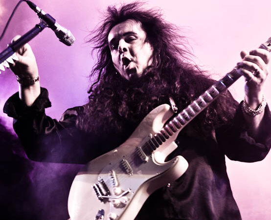 Yngwie Malmsteen playing guitar on stage in Moscow 2010