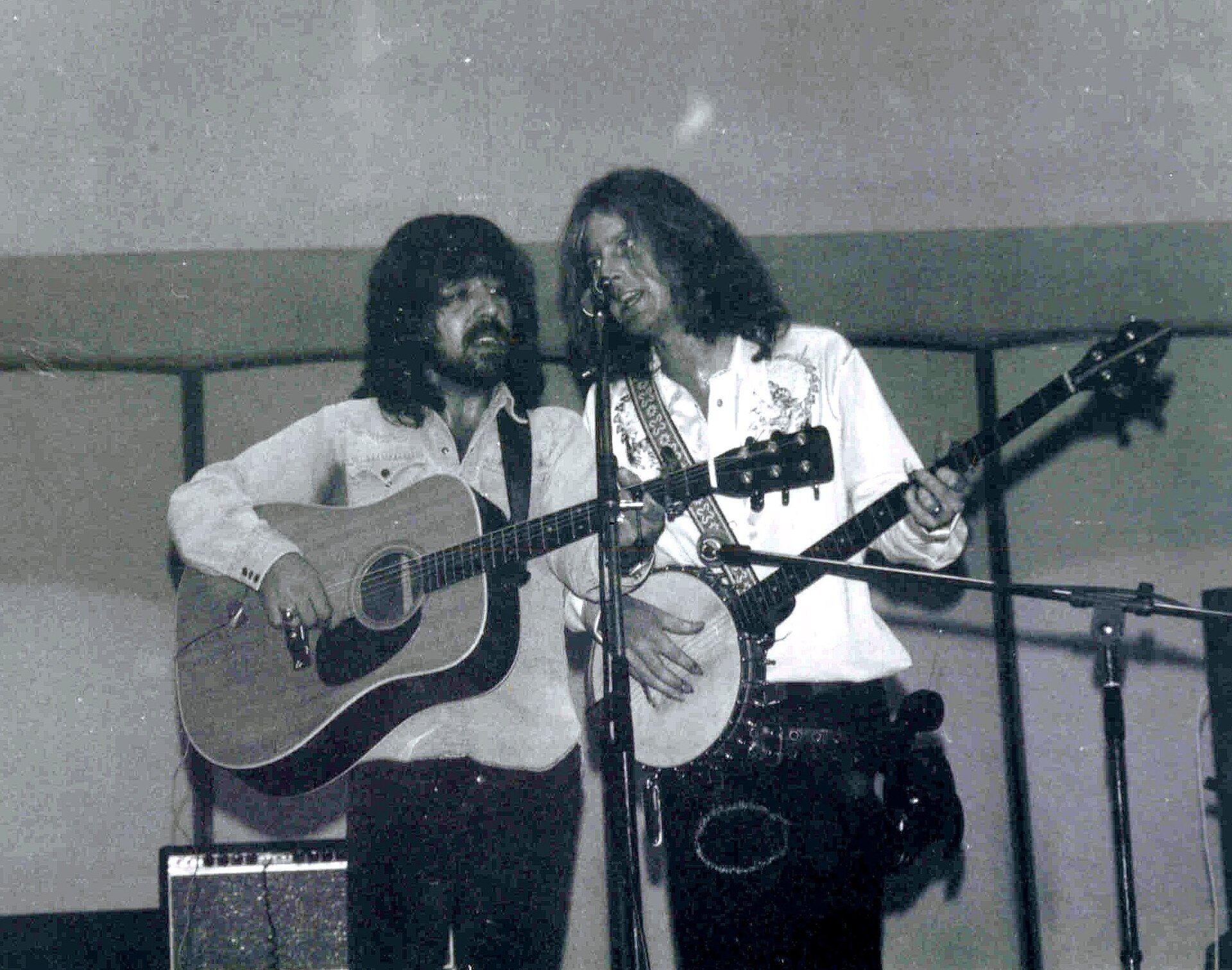 Clarence White playing acoustic guitar beside Roger McGuinn on banjo in 1972