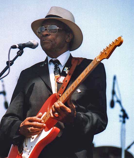 Hubert Sumlin in a hat and dark suit playing a red Stratocaster at the Long Beach Blues Festival in 2003