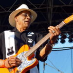 Hubert Sumlin guitar technique on stage at the 2006 Sioux Falls JazzFest, picking an orange Telecaster style guitar with his bare fingers
