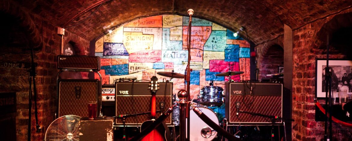 Small pub stage set up with amps, drums and a guitar before a gig