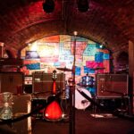 Small pub stage set up with amps, drums and a guitar before a gig