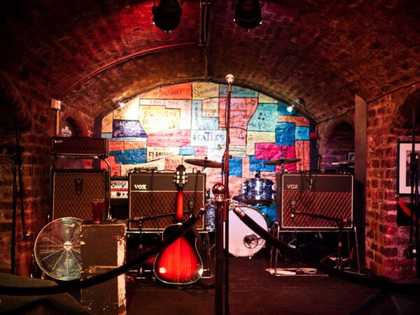 Small pub stage set up with amps, drums and a guitar before a gig