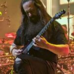 John Petrucci playing live in Milan in 2024; his guitar practice routine splits time into short blocks