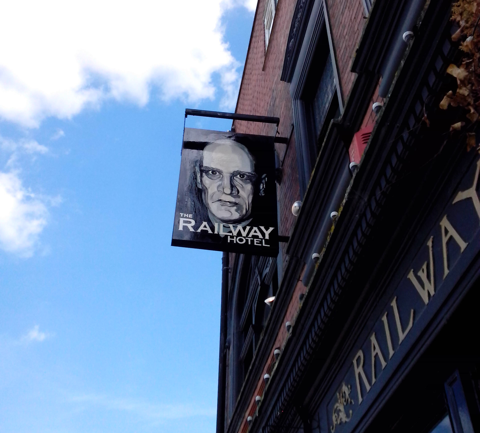 Railway Hotel pub sign in Southend on Sea showing a painted portrait of Wilko Johnson