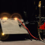 Wilko Johnson's black Telecaster with a red scratchplate beside a Fender Twin Reverb amp on stage in 2014