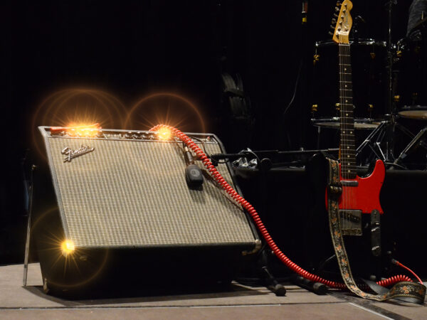 Wilko Johnson's black Telecaster with a red scratchplate beside a Fender Twin Reverb amp on stage in 2014