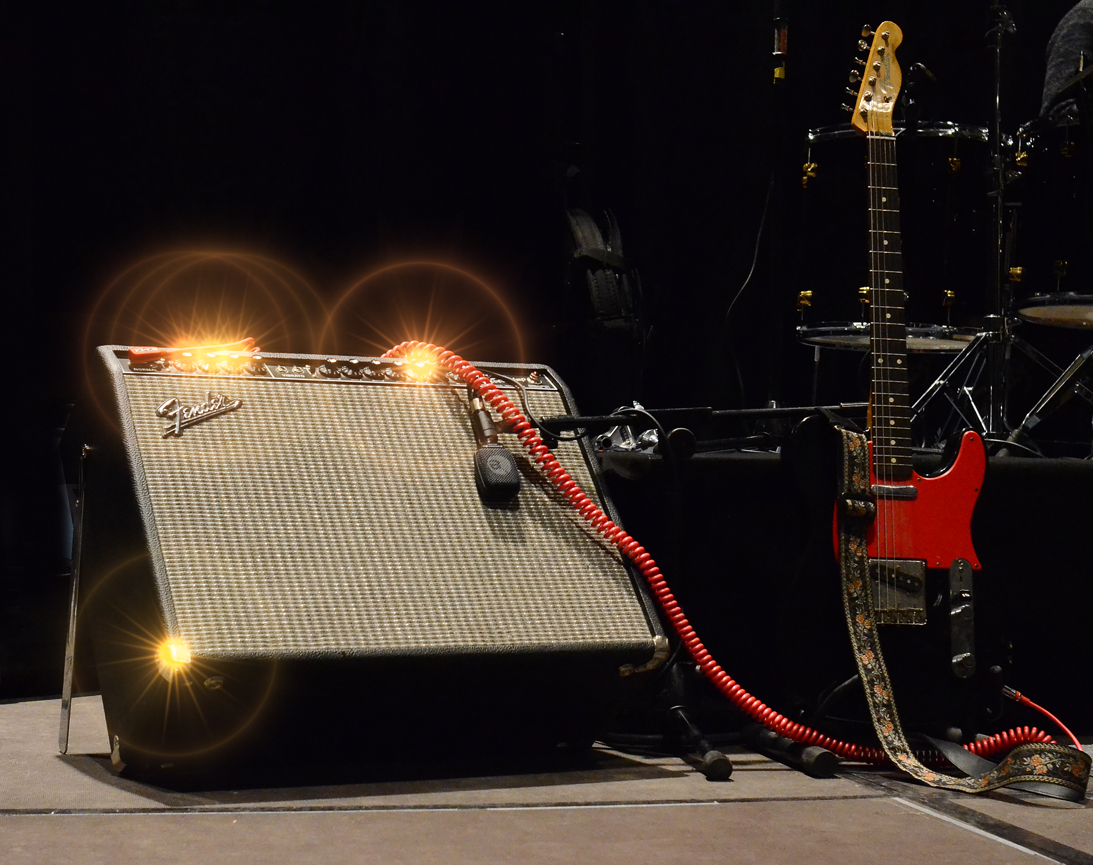 Wilko Johnson's black Telecaster with a red scratchplate beside a Fender Twin Reverb amp on stage in 2014