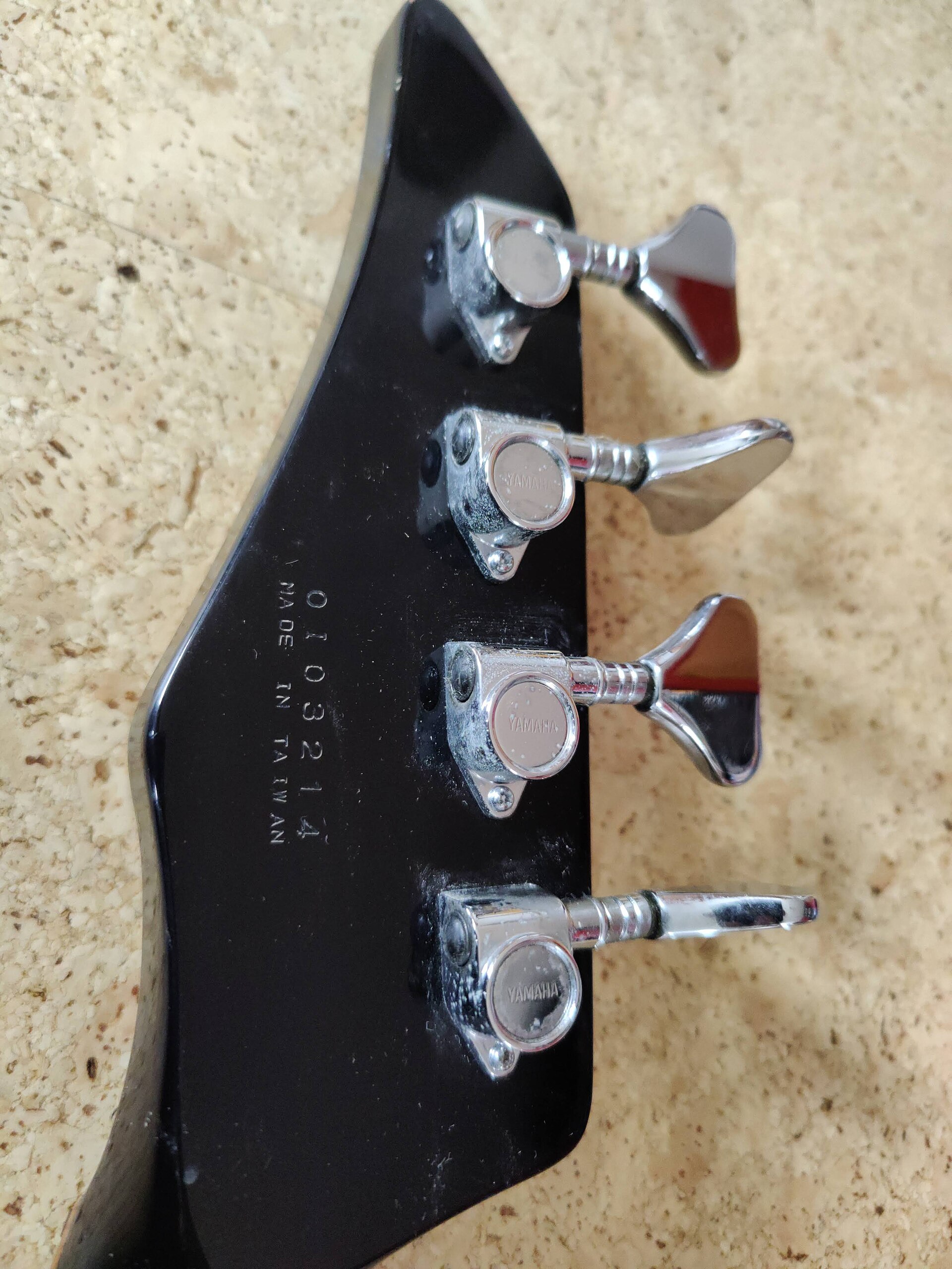 Headstock and tuners of a Yamaha bass, worth checking on a second hand bass